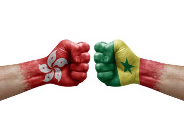 Two hands punch to each others on white background. Country flags painted fists, conflict crisis concept between hong kong and senegal
