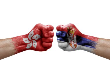 Two hands punch to each others on white background. Country flags painted fists, conflict crisis concept between hong kong and serbia