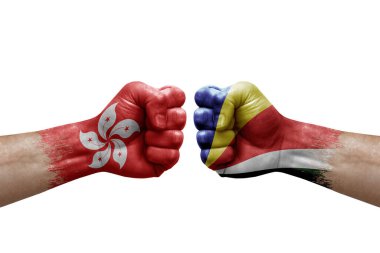 Two hands punch to each others on white background. Country flags painted fists, conflict crisis concept between hong kong and seychelles