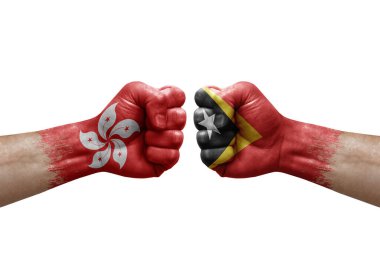 Two hands punch to each others on white background. Country flags painted fists, conflict crisis concept between hong kong and timor leste