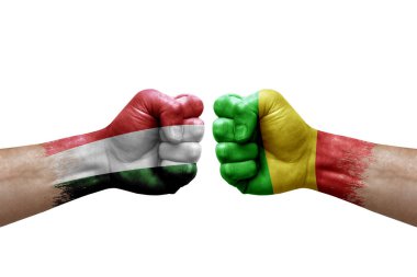 Two hands punch to each others on white background. Country flags painted fists, conflict crisis concept between hungary and mali