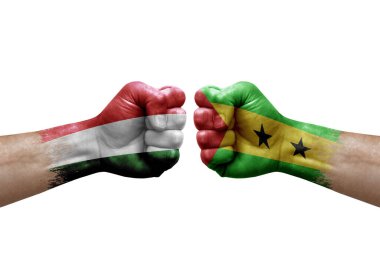 Two hands punch to each others on white background. Country flags painted fists, conflict crisis concept between hungary and sao tome and principe