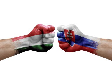 Two hands punch to each others on white background. Country flags painted fists, conflict crisis concept between hungary and slovakia