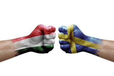 Two hands punch to each others on white background. Country flags painted fists, conflict crisis concept between hungary and sweden