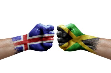 Two hands punch to each others on white background. Country flags painted fists, conflict crisis concept between iceland and jamaica