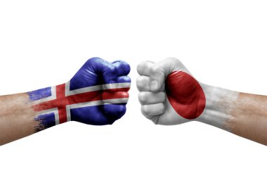 Two hands punch to each others on white background. Country flags painted fists, conflict crisis concept between iceland and japan