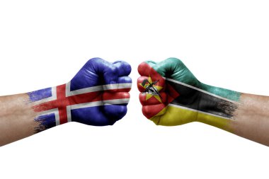 Two hands punch to each others on white background. Country flags painted fists, conflict crisis concept between iceland and mozambique
