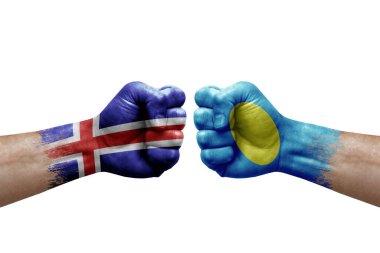Two hands punch to each others on white background. Country flags painted fists, conflict crisis concept between iceland and palau