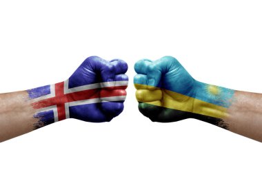 Two hands punch to each others on white background. Country flags painted fists, conflict crisis concept between iceland and rwanda