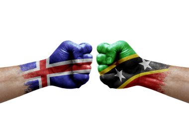 Two hands punch to each others on white background. Country flags painted fists, conflict crisis concept between iceland and saint kitts and nevis