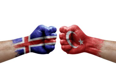 Two hands punch to each others on white background. Country flags painted fists, conflict crisis concept between iceland and turkey