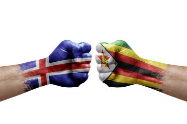 Two hands punch to each others on white background. Country flags painted fists, conflict crisis concept between iceland and zimbabwe
