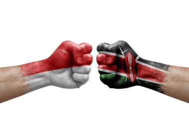 Two hands punch to each others on white background. Country flags painted fists, conflict crisis concept between indonesia and kenya