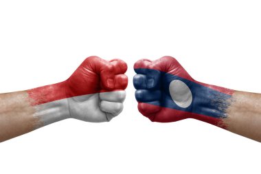 Two hands punch to each others on white background. Country flags painted fists, conflict crisis concept between indonesia and laos