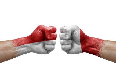 Two hands punch to each others on white background. Country flags painted fists, conflict crisis concept between indonesia and malta