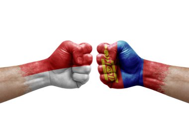 Two hands punch to each others on white background. Country flags painted fists, conflict crisis concept between indonesia and mongolia