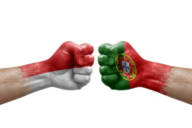 Two hands punch to each others on white background. Country flags painted fists, conflict crisis concept between indonesia and portugal
