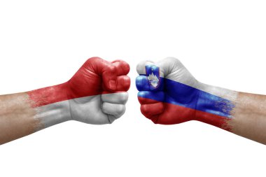 Two hands punch to each others on white background. Country flags painted fists, conflict crisis concept between indonesia and slovenia