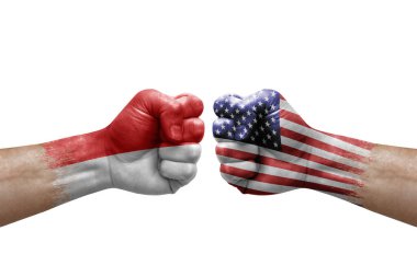 Two hands punch to each others on white background. Country flags painted fists, conflict crisis concept between indonesia and usa
