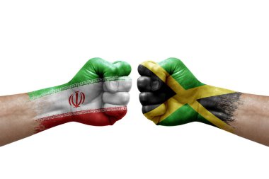 Two hands punch to each others on white background. Country flags painted fists, conflict crisis concept between iran and jamaica
