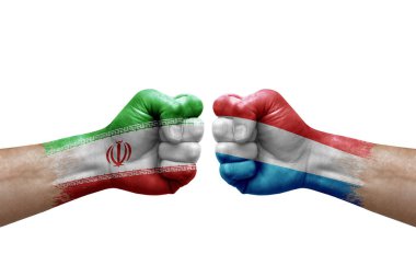 Two hands punch to each others on white background. Country flags painted fists, conflict crisis concept between iran and luxembourg