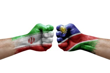 Two hands punch to each others on white background. Country flags painted fists, conflict crisis concept between iran and namibia