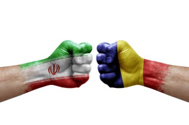 Two hands punch to each others on white background. Country flags painted fists, conflict crisis concept between iran and romania