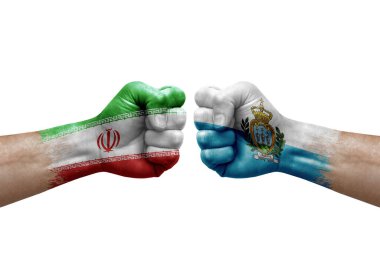 Two hands punch to each others on white background. Country flags painted fists, conflict crisis concept between iran and san marino