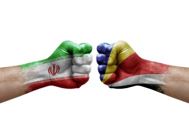 Two hands punch to each others on white background. Country flags painted fists, conflict crisis concept between iran and seychelles