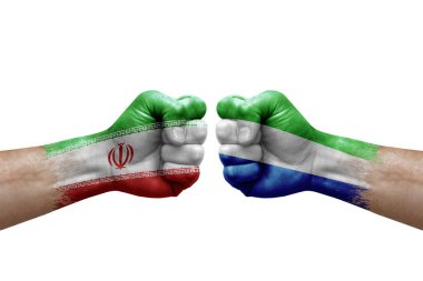 Two hands punch to each others on white background. Country flags painted fists, conflict crisis concept between iran and sierra leone