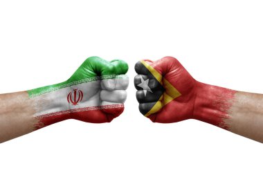 Two hands punch to each others on white background. Country flags painted fists, conflict crisis concept between iran and timor leste