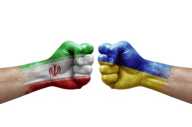 Two hands punch to each others on white background. Country flags painted fists, conflict crisis concept between iran and ukraine