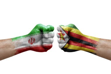 Two hands punch to each others on white background. Country flags painted fists, conflict crisis concept between iran and zimbabwe