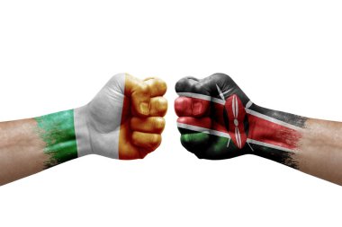 Two hands punch to each others on white background. Country flags painted fists, conflict crisis concept between ireland and kenya