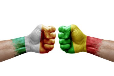 Two hands punch to each others on white background. Country flags painted fists, conflict crisis concept between ireland and mali