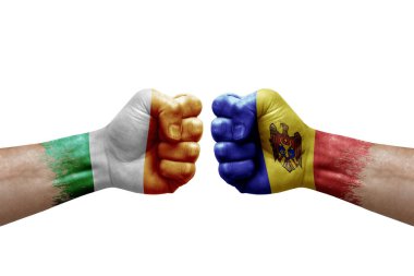 Two hands punch to each others on white background. Country flags painted fists, conflict crisis concept between ireland and moldova