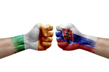 Two hands punch to each others on white background. Country flags painted fists, conflict crisis concept between ireland and slovakia