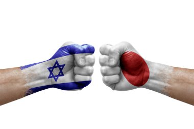 Two hands punch to each others on white background. Country flags painted fists, conflict crisis concept between israel and japan