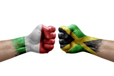Two hands punch to each others on white background. Country flags painted fists, conflict crisis concept between italy and jamaica