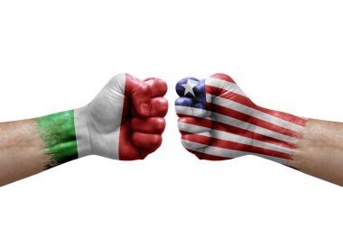 Two hands punch to each others on white background. Country flags painted fists, conflict crisis concept between italy and liberia