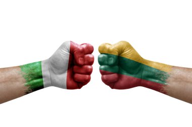 Two hands punch to each others on white background. Country flags painted fists, conflict crisis concept between italy and lithuania