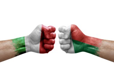 Two hands punch to each others on white background. Country flags painted fists, conflict crisis concept between italy and madagascar