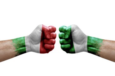 Two hands punch to each others on white background. Country flags painted fists, conflict crisis concept between italy and nigeria