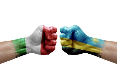 Two hands punch to each others on white background. Country flags painted fists, conflict crisis concept between italy and rwanda