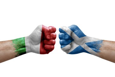 Two hands punch to each others on white background. Country flags painted fists, conflict crisis concept between italy and scotland