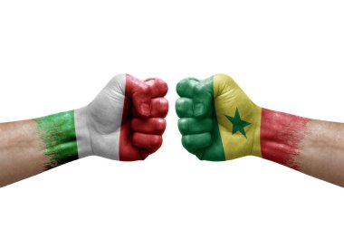 Two hands punch to each others on white background. Country flags painted fists, conflict crisis concept between italy and senegal
