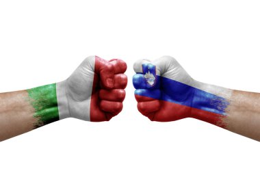 Two hands punch to each others on white background. Country flags painted fists, conflict crisis concept between italy and slovenia