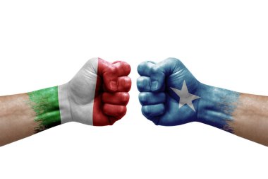 Two hands punch to each others on white background. Country flags painted fists, conflict crisis concept between italy and somalia