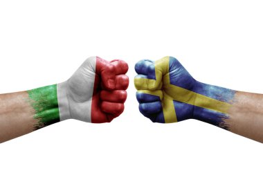 Two hands punch to each others on white background. Country flags painted fists, conflict crisis concept between italy and sweden