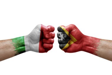 Two hands punch to each others on white background. Country flags painted fists, conflict crisis concept between italy and timor leste